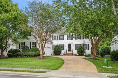 Colonial house with a garage and a front lawn | Image 2