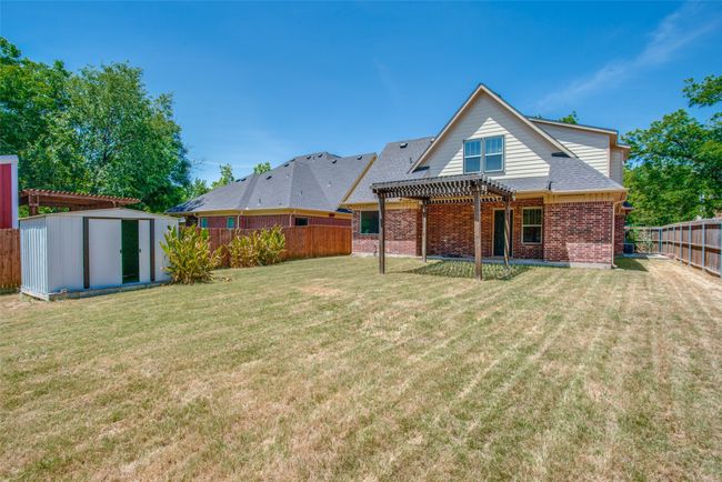 Rear view of property with a pergola and brick siding | Image 12