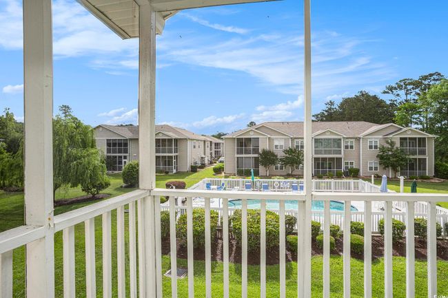 Balcony with a residential view and view of pool area | Image 16