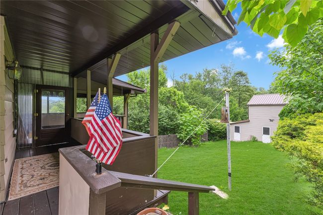 Large covered side porch, bldg in distance is lower portion of the garage, workshop/shed | Image 22