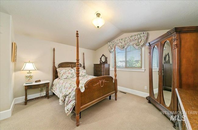 Bedroom featuring vaulted ceiling and light colored carpet | Image 33