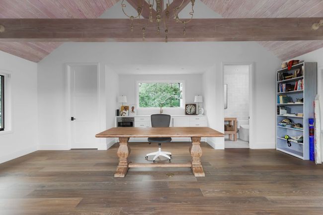 Office space featuring a chandelier, wood ceiling, and wood finished floors | Image 35
