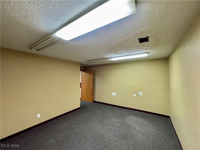 Carpeted spare room with a textured ceiling | Image 11