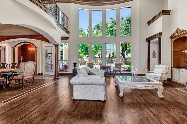 Your first glimpse of the wonders of the home is the formal living room with a soaring ceiling, double row of windows with shining backyard views and so much exquisite detail you won't know where to look first. | Image 5