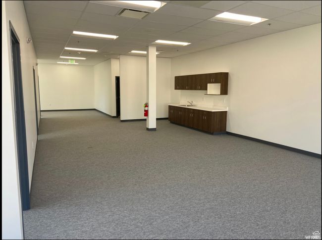 Carpeted spare room with a sink, visible vents, baseboards, and a paneled ceiling | Image 6