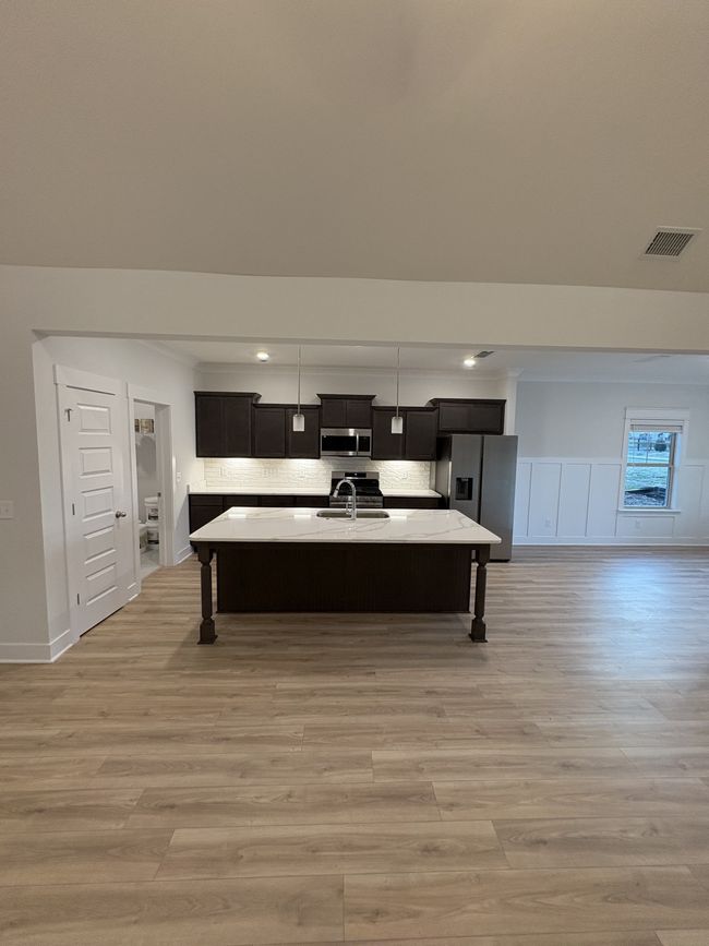 STOCK PHOTO. SELECTIONS WILL VARY IN ACTUAL HOUSE. Kitchen features large island and all stainless steel appliances. | Image 8