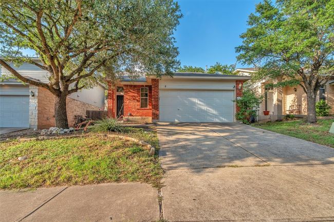 View of front of property with brick siding, an attached garage, and driveway | Image 27