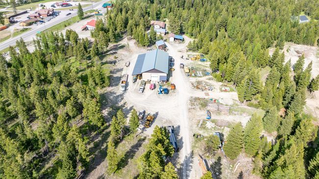 Aerial view of property and surrounding area with a heavily wooded area | Image 91