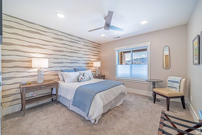 Bedroom featuring an accent wall, light carpet, baseboards, a ceiling fan, and recessed lighting | Image 20