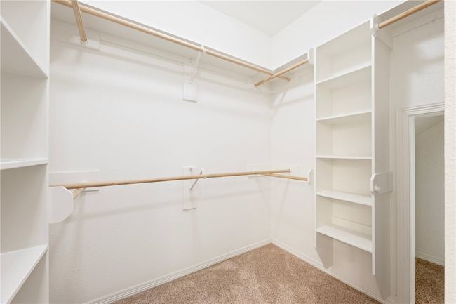 Walk in closet featuring carpet flooring | Image 15
