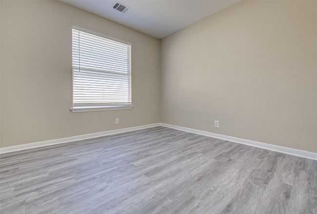 Empty room with light wood-style floors | Image 11