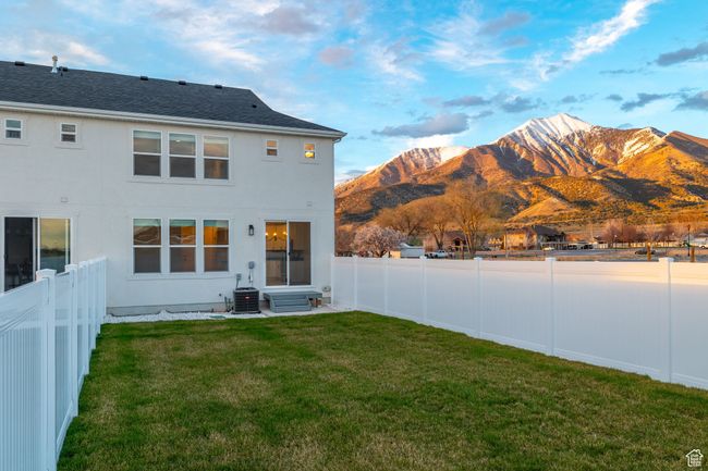 Back house at dusk with a patio | Image 31