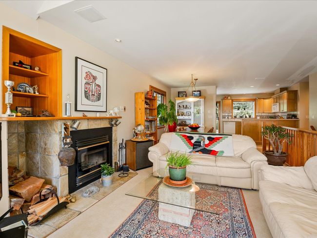 Living room with recessed lighting and a glass covered fireplace | Image 5