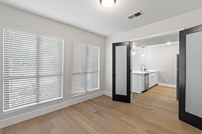 Unfurnished bedroom with a sink, baseboards, and light wood-style flooring | Image 15