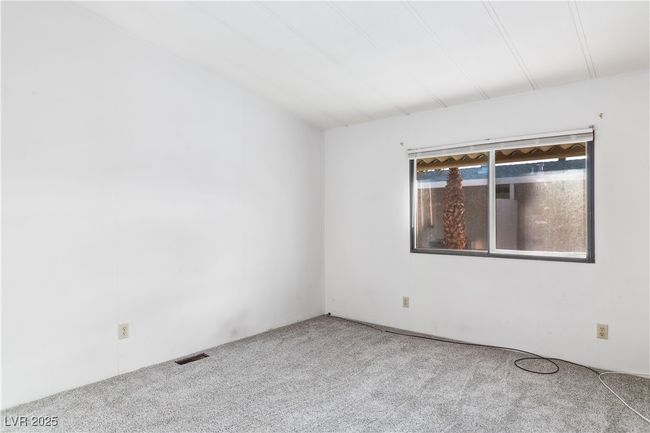 Primary bedroom featuring carpet floors and visible vents | Image 21
