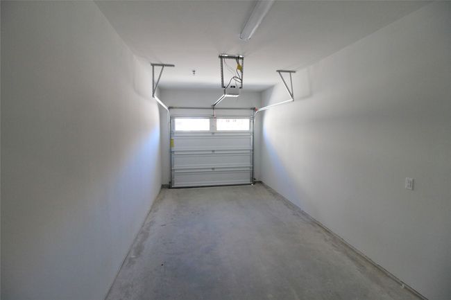 Garage featuring a garage door opener | Image 13