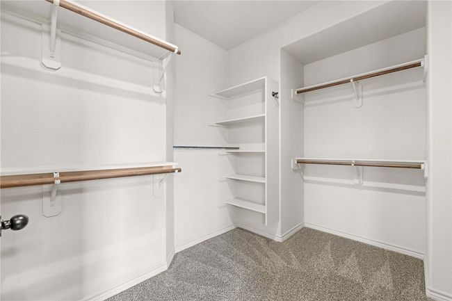 Walk in closet with carpet floors | Image 15