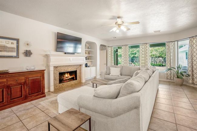 The open floor plan offers your family a spacious living room with cozy fireplace and tiled floors which are maintenance free. | Image 12