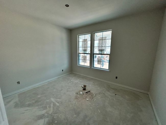 Empty room with unfinished concrete flooring and baseboards | Image 11