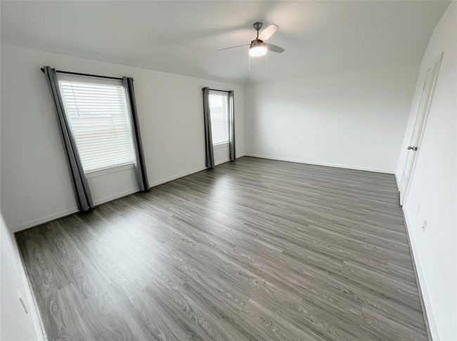 Primary Bedroom with an elevated ceiling | Image 9
