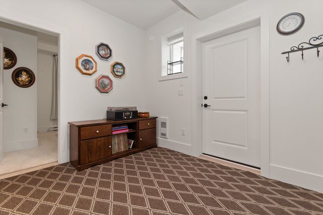 Entryway with dark colored carpet, baseboard heating, and baseboards | Image 31