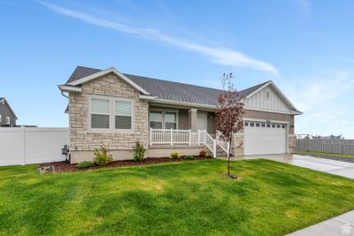 Single story home with covered porch, a front lawn, and a garage | Image 2