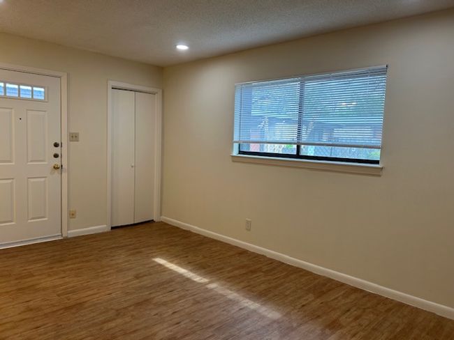 Foyer with baseboards, a textured ceiling, wood finished floors, and recessed lighting | Image 8