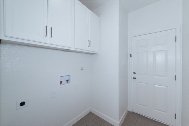 Laundry room, Washer/dryer hookups both gas and electric, door on right leads to garage with garage door opener | Image 27