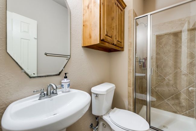 Full bathroom featuring a sink, toilet, and a shower stall | Image 14