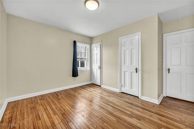 Unfurnished bedroom featuring baseboards and light wood finished floors | Image 35