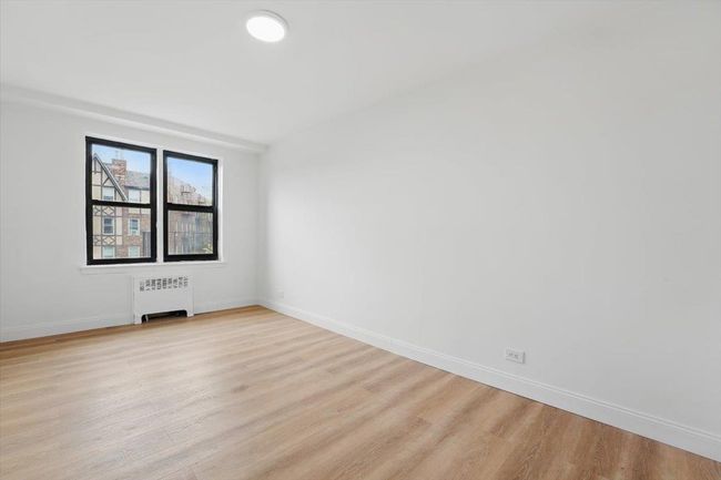 Unfurnished room featuring baseboards, light wood-style floors, and radiator | Image 19