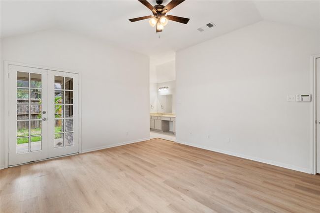 Angle shows seamless transition from bedroom to bath, with great wall space for furniture. | Image 15