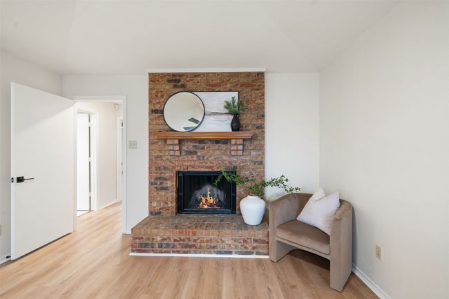 Primary bedroom with fireplace and vaulted ceiling. | Image 13