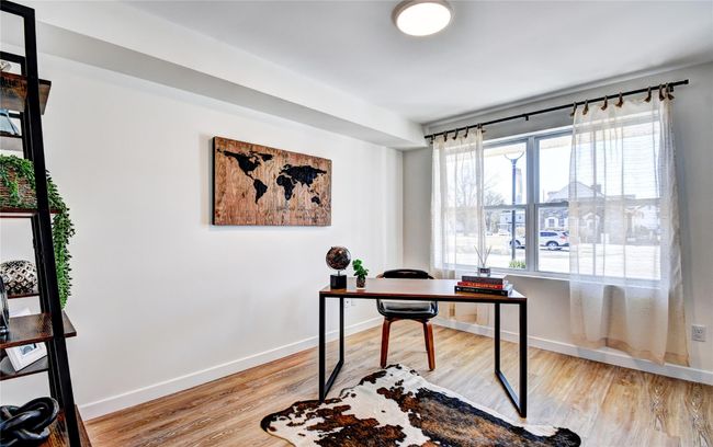 Office space with wood finished floors and baseboards | Image 11