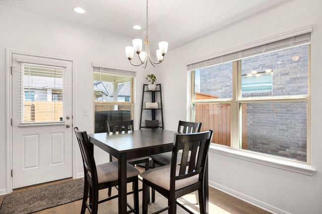 Dining room with wood finished floors, a chandelier, and recessed lighting | Image 11