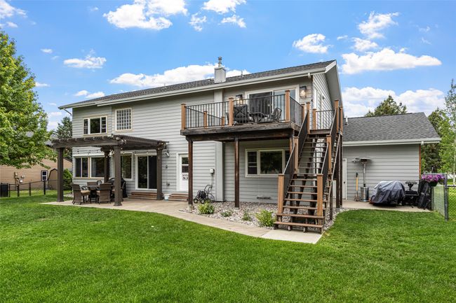 Back of house with a pergola, a fenced backyard, entry steps, and stairs | Image 56