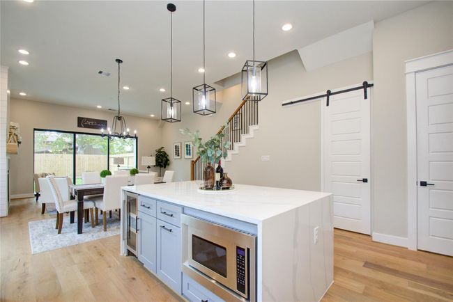 Waterfall, marble island with built in wine cooler and microwave | Image 11