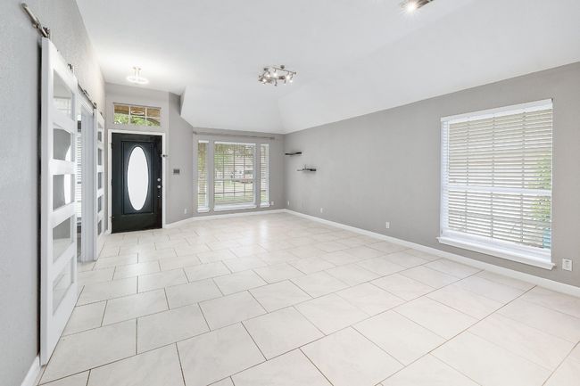 Foyer featuring baseboards, light tile patterned flooring, and vaulted ceiling | Image 15