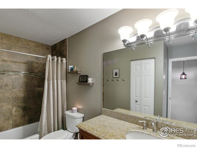 Note the gorgeous granite countertop and ceramic tile in the full bath on the upper level. | Image 16
