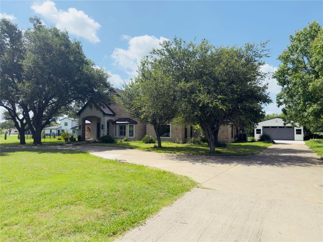 View of front of home featuring a front lawn, an outbuilding, and curved driveway | Image 40