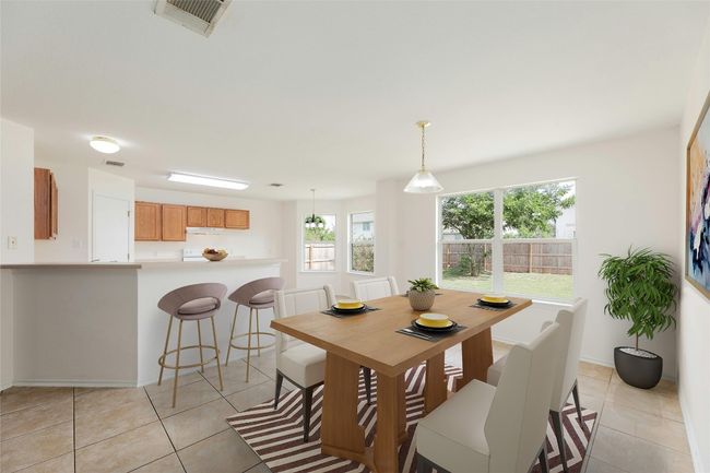 Dining area with light tile patterned floors and baseboards | Image 5