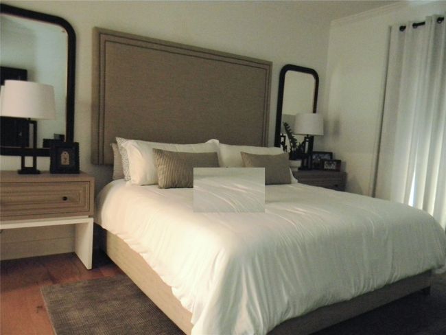 Bedroom featuring wood finished floors and doors to access exterior side patio. | Image 10