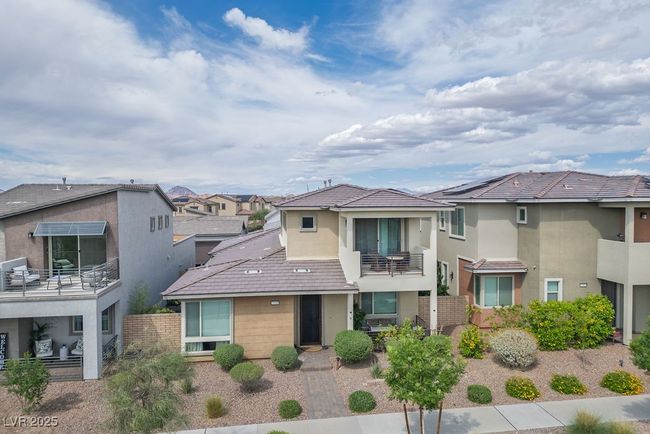 View of front of house featuring stucco siding, a balcony, and a residential view | Image 6