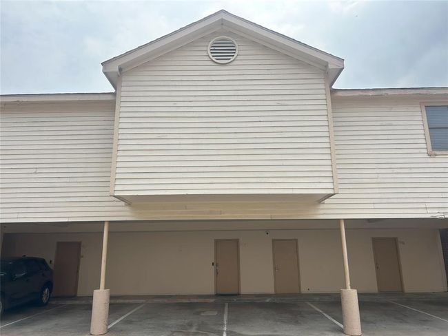 There are two covered parking spaces just outside the unit, with direct access and a storage closet (middle door). | Image 39