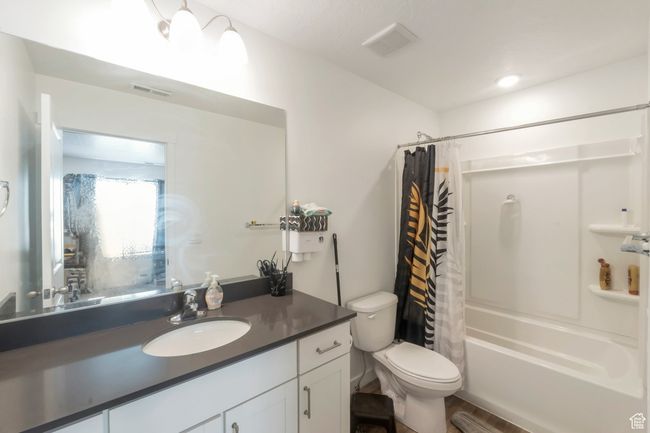 Full bathroom featuring vanity, shower / bath combination with curtain, and wood finished floors | Image 7