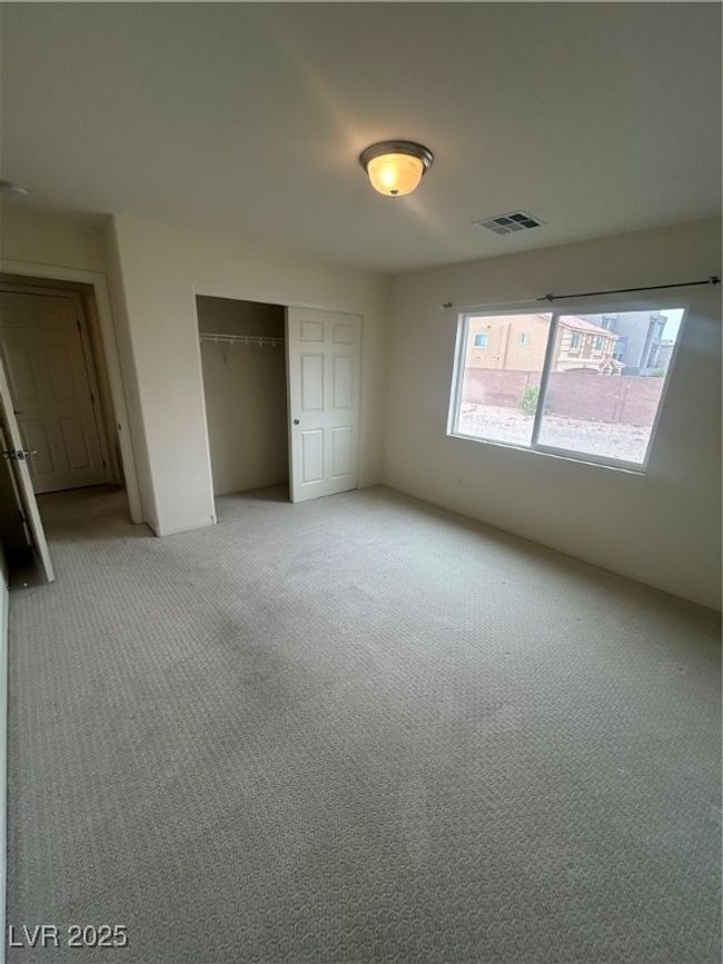 Unfurnished bedroom with light colored carpet and a closet | Image 14