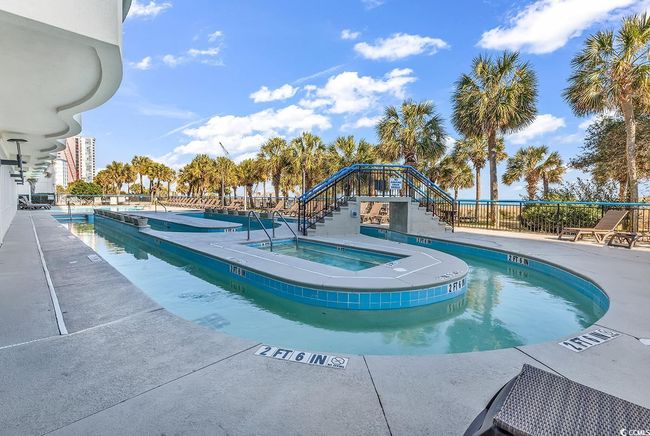 Community pool featuring a community hot tub, stairs, and a patio area | Image 19