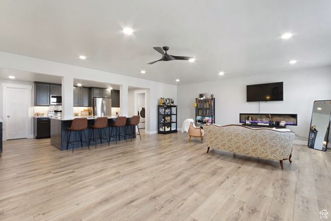 Living area featuring recessed lighting, light wood-type flooring, a ceiling fan, and baseboards | Image 22