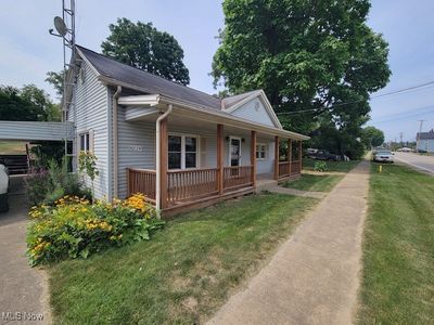 View of front of home featuring a front yard and covered porch | Image 2