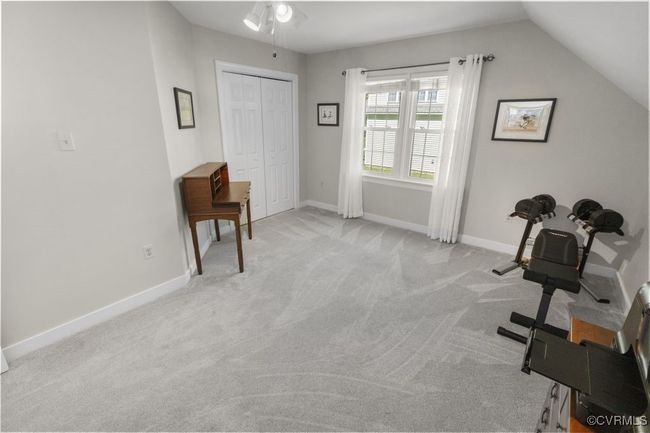 Living area featuring light carpet, a ceiling fan, baseboards, and vaulted ceiling | Image 36